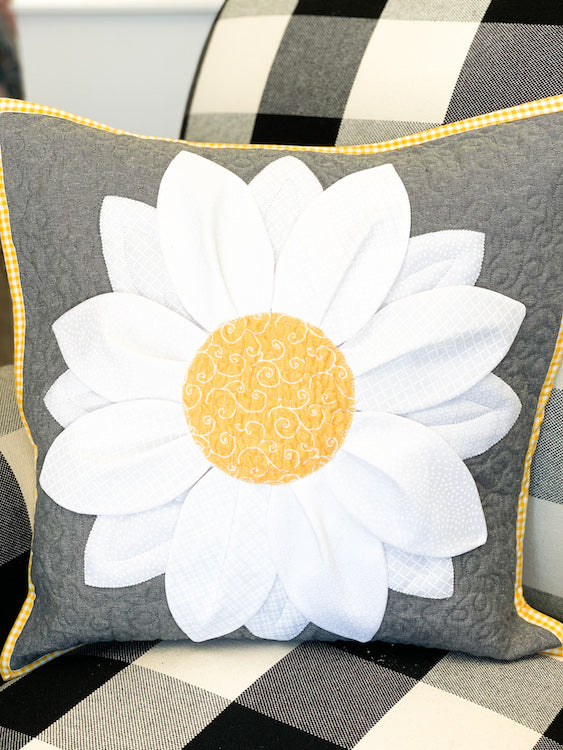 white and yellow flower pillow