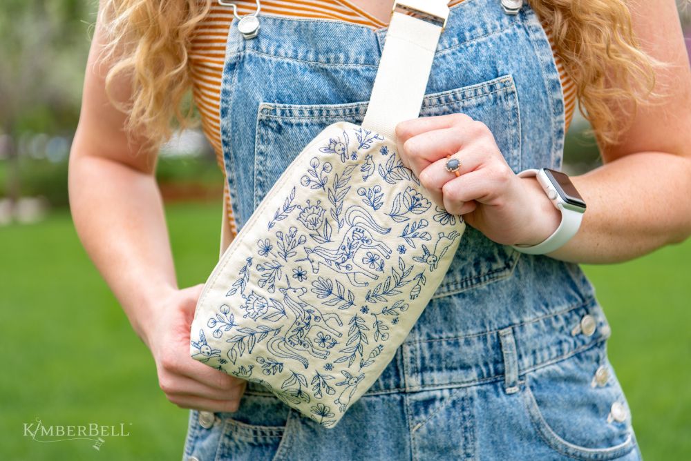 Canvas cream zipper pouch with blue embroidery designs 