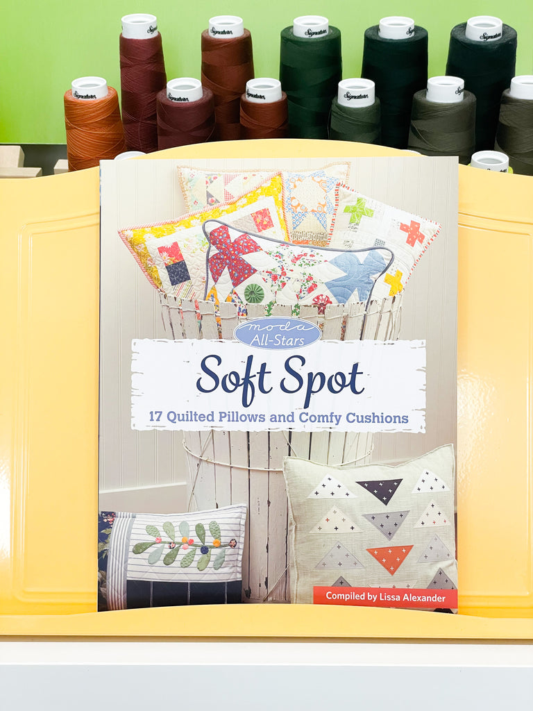 Moda All-Stars Soft spot book in front of spools of thread 