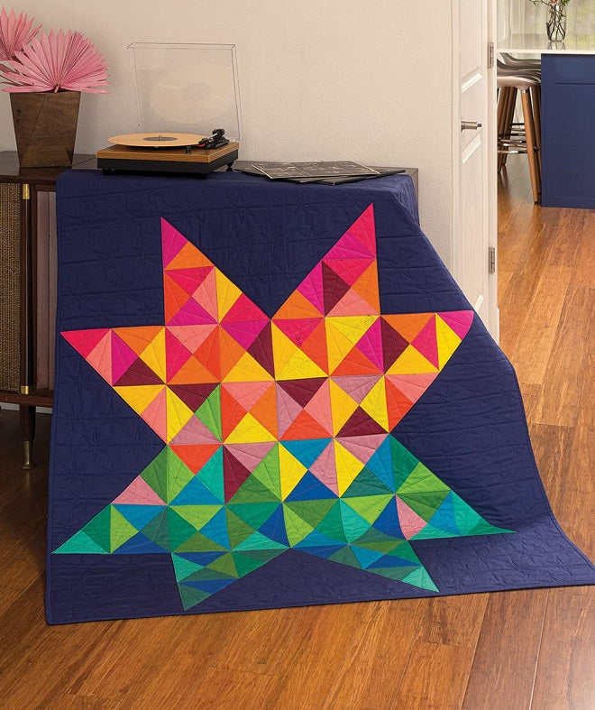 Multi colored star pattern on a navy blue backgrounded quilt 