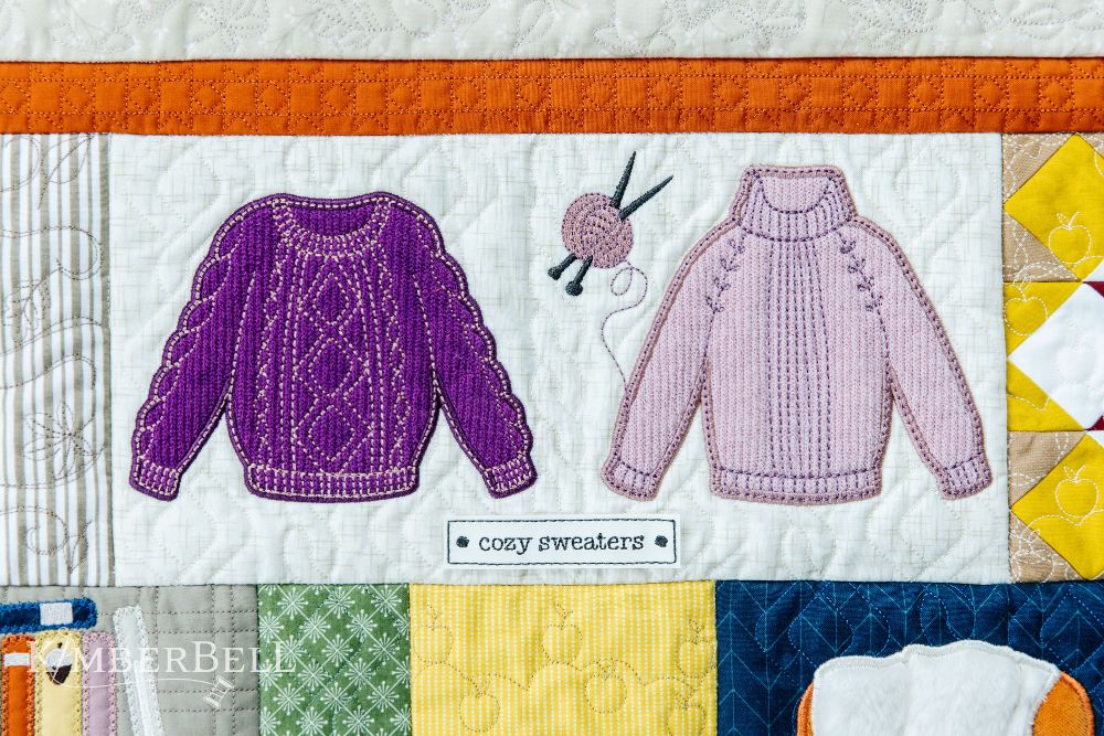 Kimberbell sweaters on quilt